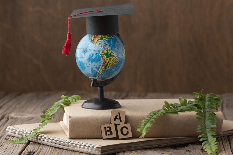 a globe with graduation cap
