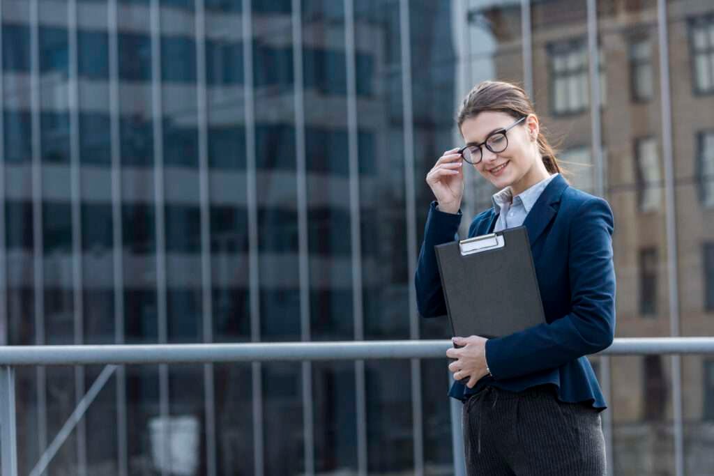 Brunette businesswoman posing confidently outdoors in a city, symbolizing career growth and job opportunities in the UK.