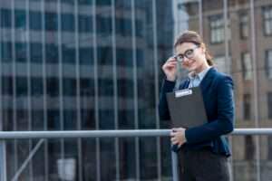 Brunette businesswoman posing confidently outdoors in a city, symbolizing career growth and job opportunities in the UK.