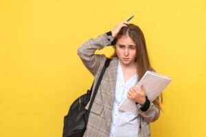 Female student with papers in her hand facing rejection